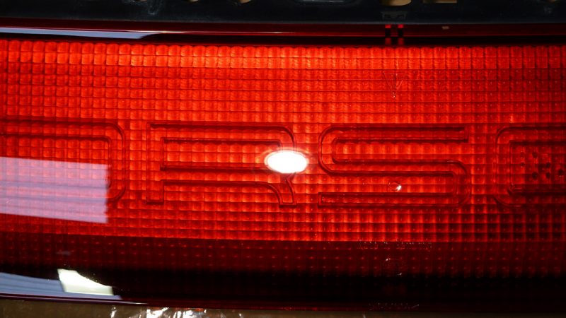 Corrected Porsche rear light bar with the lettering crisp and the lens clear
