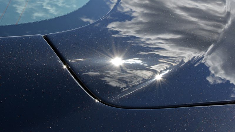 Sunlight reflecting cleanly off the polished bonnet of the Aston Martin DBS