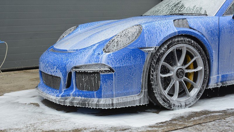 Porsche 991 GT3 RS in Voodoo Blue covered in snow foam during the pre-wash