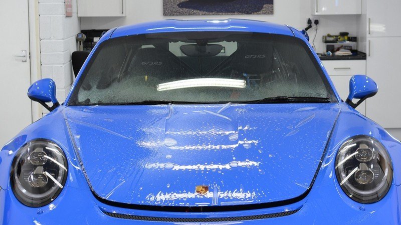 Self-healing paint protection film being laid over the GT3 RS bonnet