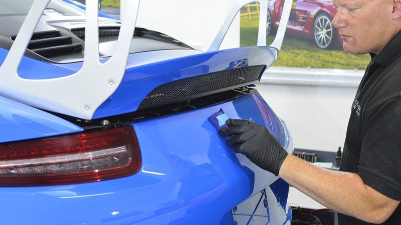 Coating being applied around the GT3 RS rear wing and engine deck