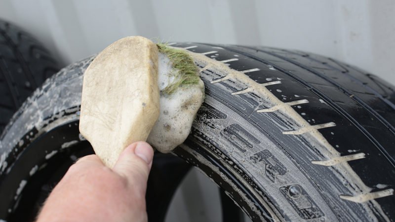 Tyre of the Aston Martin Vanquish being cleaned by hand