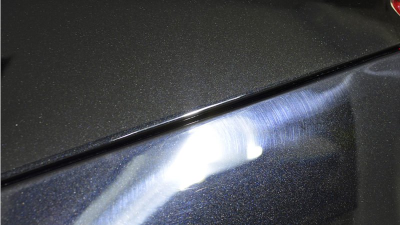 Defect in the Vanquish paint picked out under high-intensity lighting
