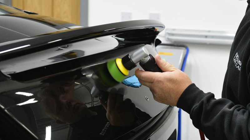 Rear spoiler of the Vanquish refined with a mini polisher