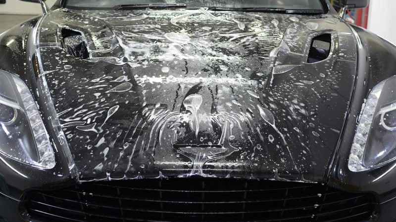 Paint protection film being applied to the Vanquish front bumper
