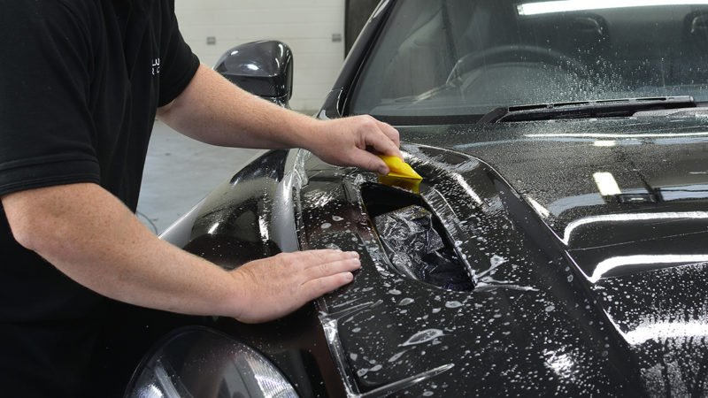 Film squeegeed down onto the bonnet of the Aston Martin Vanquish