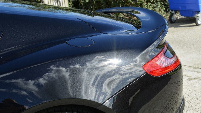 Rear haunch and light cluster of the polished Aston Martin Vanquish