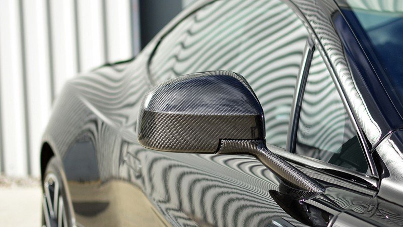 Carbon fibre mirror cap of the Vanquish protected with film