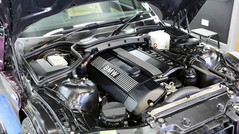 Detailed BMW Z3 engine bay with the six-cylinder cover cleaned and dressed