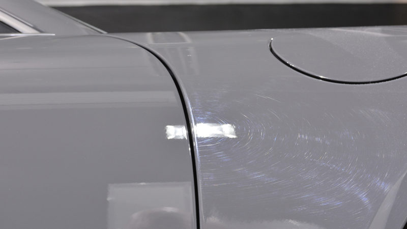Swirl marks in the rear quarter panel of the Porsche 911 50th Anniversary picked out by inspection lighting