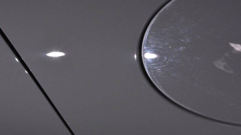 Wash marring around the fuel flap and rear wing of the Porsche 911 before machine polishing