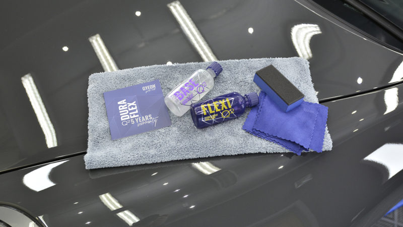 Gyeon Q2 DuraFlex Base and Flexi bottles, applicator and warranty card on the Porsche 911 bonnet