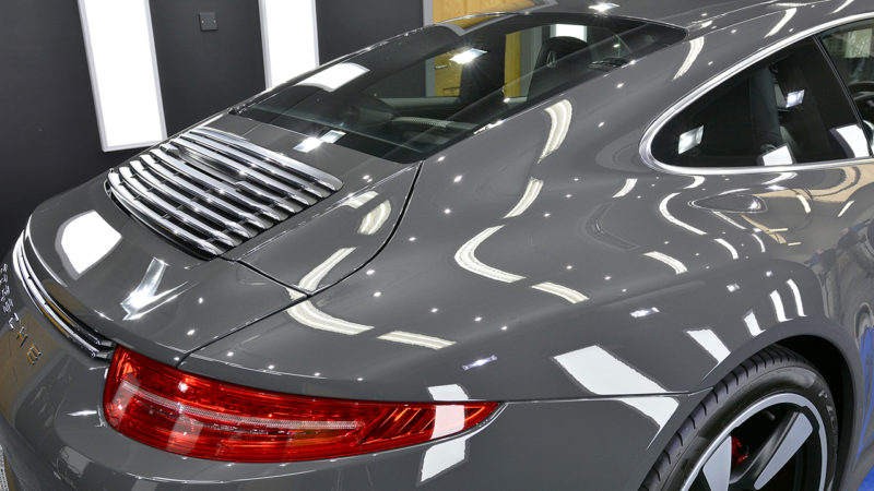 Rear three-quarter of the Porsche 911 50th Anniversary after machine polishing, taillight and engine grille