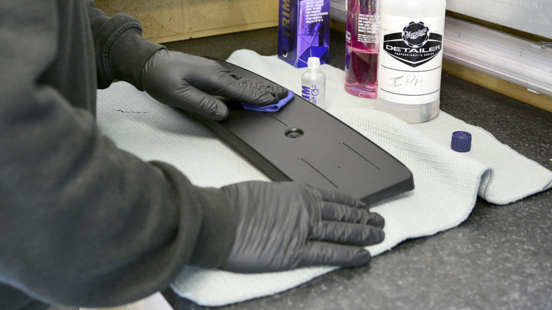 Black trim panel from the Porsche 911 cleaned on the bench before coating