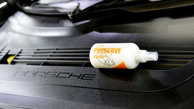 Gyeon Q2 Preserve on the engine lid of the Porsche 911 beside the chrome PORSCHE script