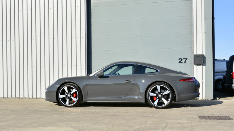 Side profile of the Graphite Grey Metallic Porsche 911 50th Anniversary in the sun