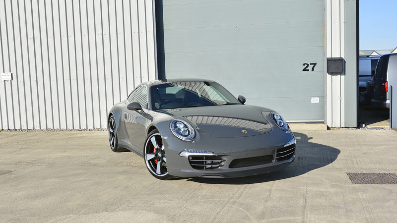 Low front three-quarter view of the Porsche 911 50th Anniversary after its Enhancement Plus detail