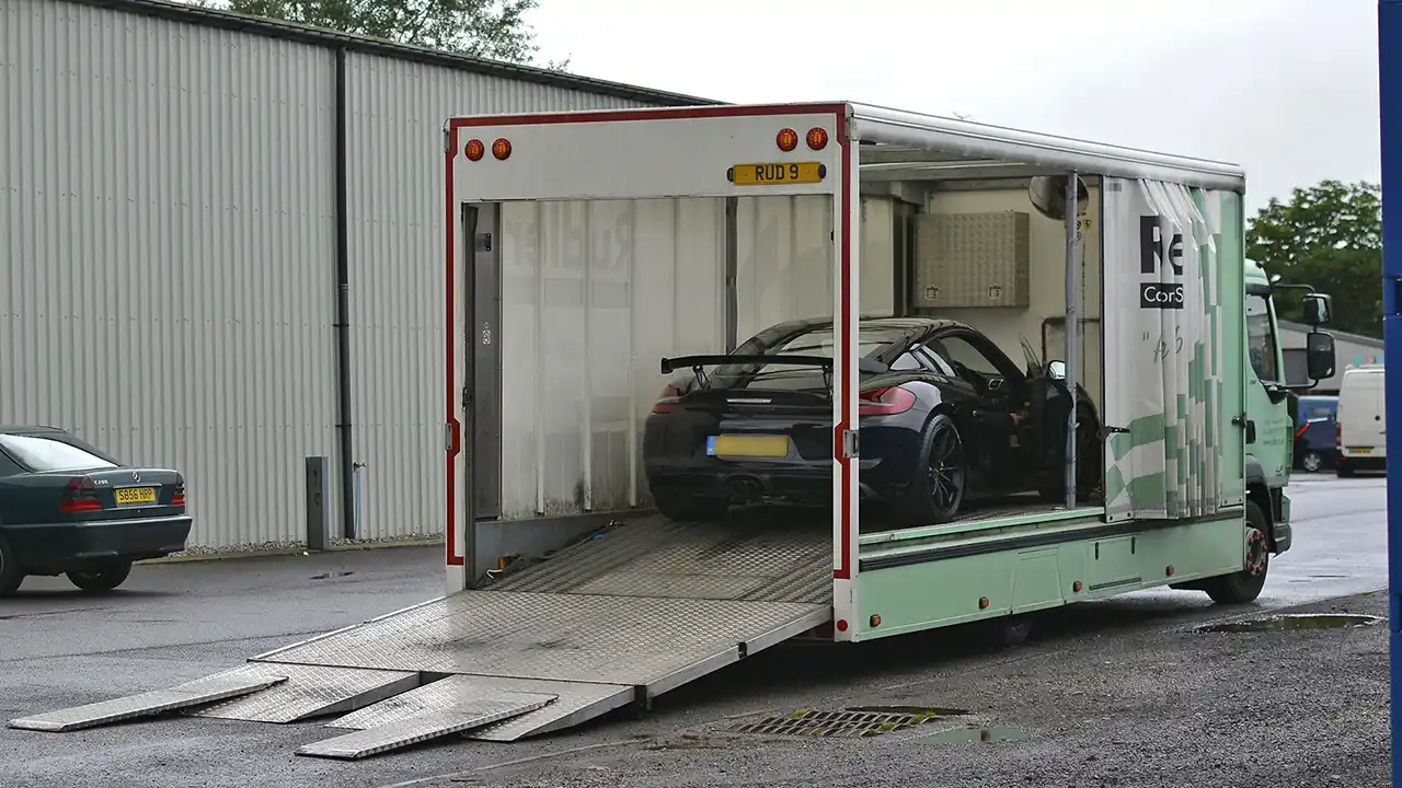 Porsche GT4 collected in an enclosed transporter