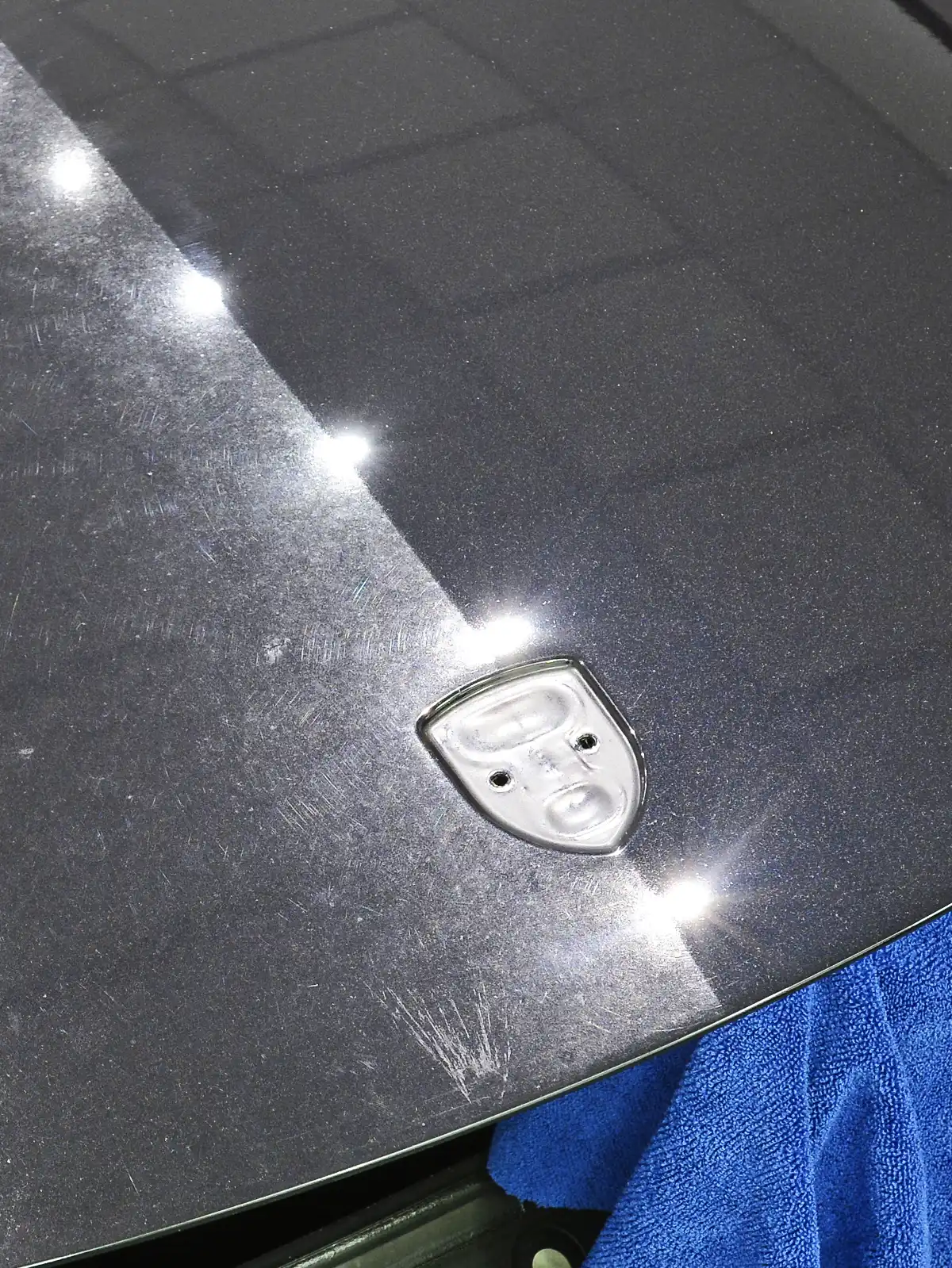 Porsche GT4 bonnet under inspection lighting during paint correction at our studio near Bath