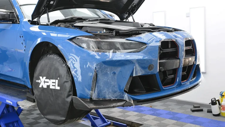 Front bumper and grille surround of the Laguna Seca Blue M3 CS Touring being covered in PPF