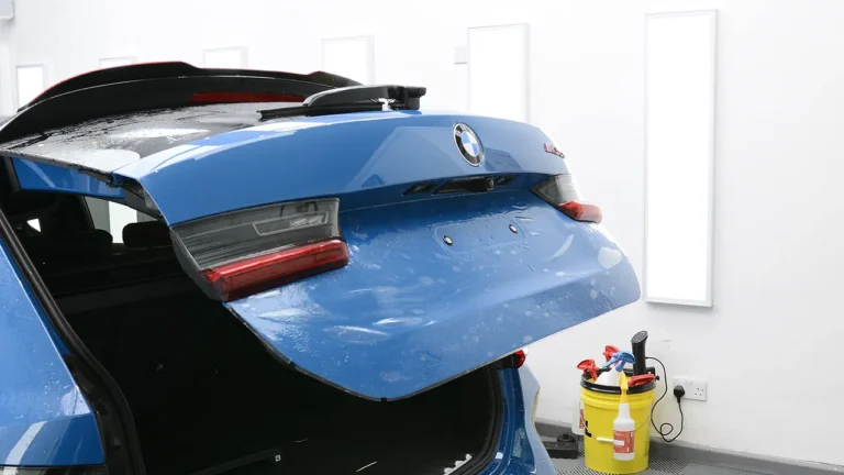 Tailgate and spoiler of the Laguna Seca Blue M3 CS Touring during wet application of PPF