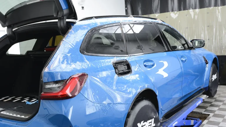 Rear quarter of the Laguna Seca Blue M3 CS Touring covered in XPEL paint protection film