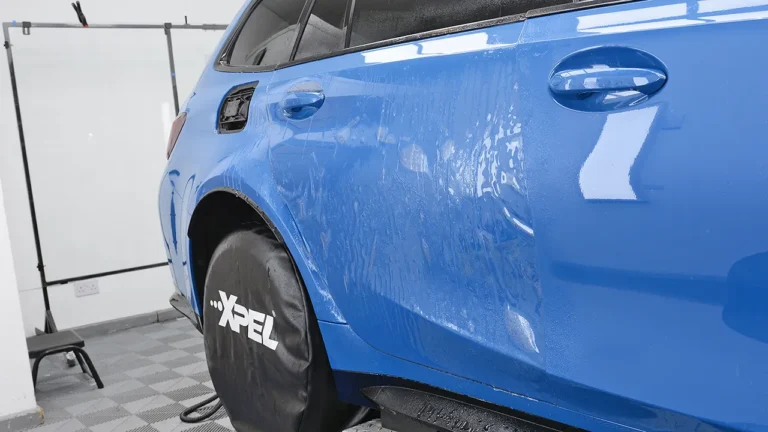 Rear door and quarter panel of the Laguna Seca Blue M3 CS Touring being filmed