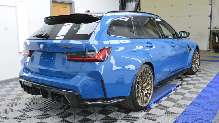 Rear three-quarter of the finished Laguna Seca Blue BMW M3 CS Touring with gold forged wheels