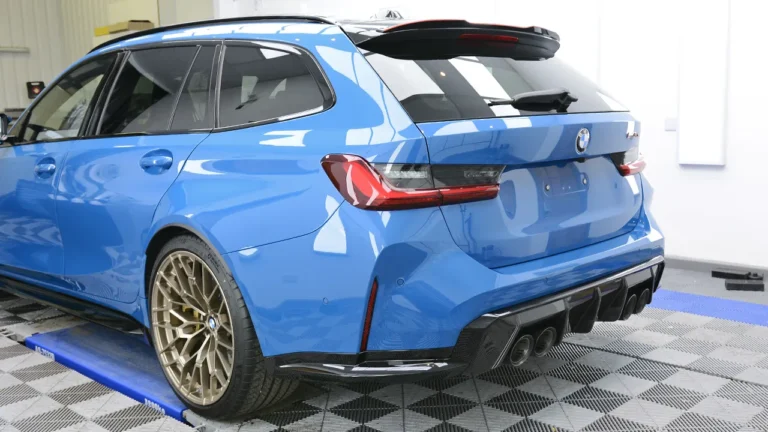 Rear view of the protected Laguna Seca Blue M3 CS Touring showing the diffuser and quad exhausts