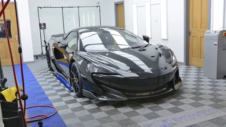 Black McLaren 600LT in the Exclusive Car Care studio after full paint protection film